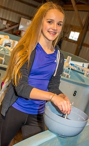 Hatchery worker stirs paddlefish eggs-3