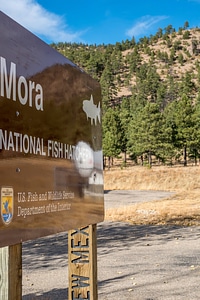 Hatchery sign and hills above Mora National Fish Hatchery