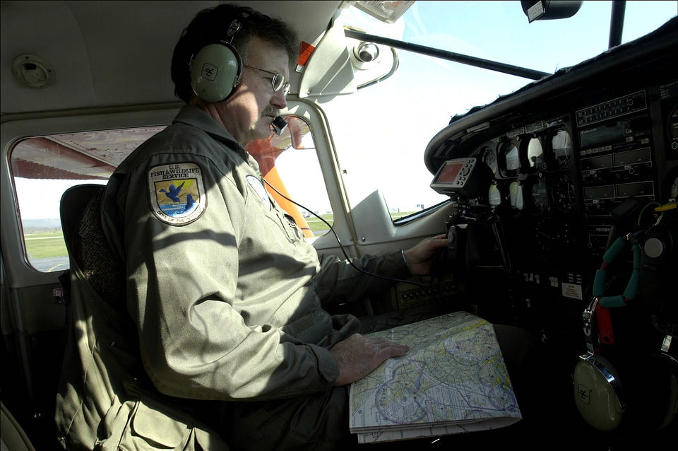 Service pilot reviewing map before takeoff