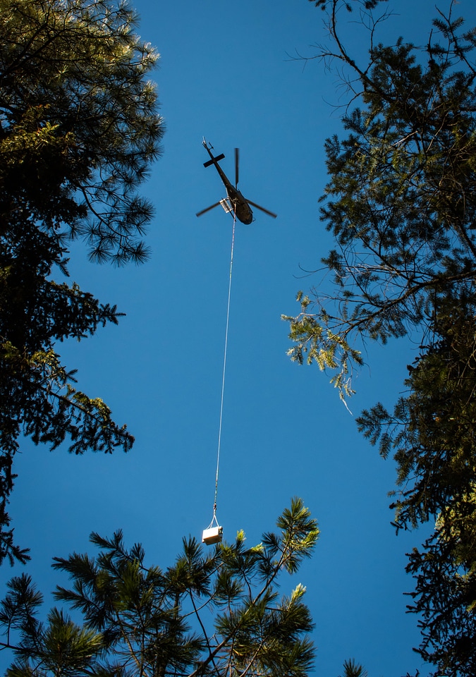 Helicopter lowers fish tank on cable-1