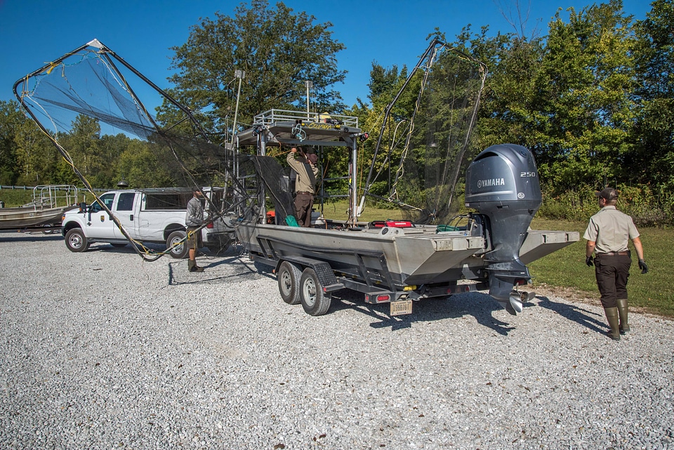 Crew of the U.S. Fish and Wildlife Service boat, The Magna Carpa, prepping boat