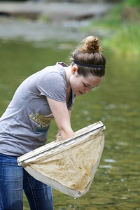 Teen girl netting macroinvertebrates