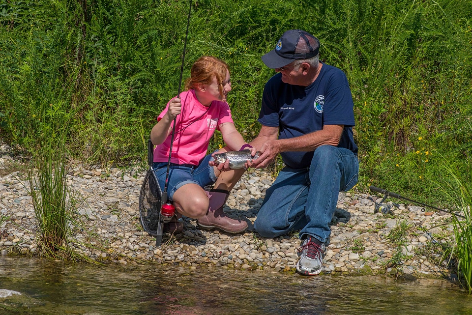 Older man with young redheaded girl and rainbow trout-2