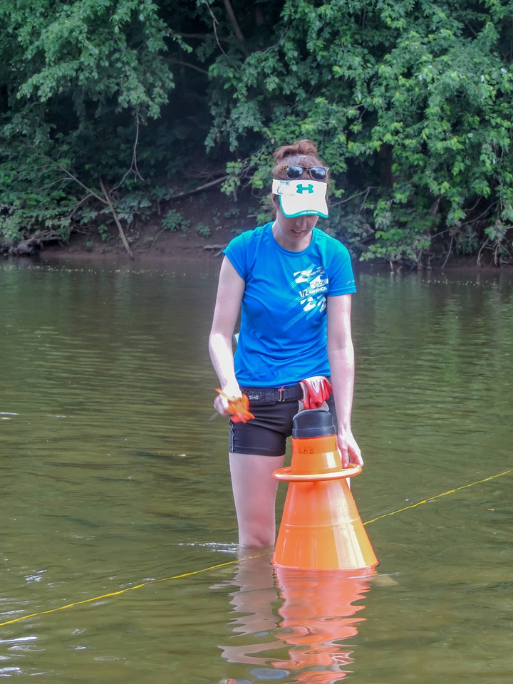 Student surveying freshwater mussels