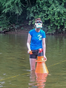 Student surveying freshwater mussels
