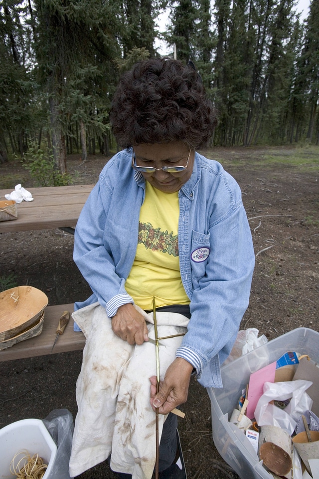 Native American woman working on crafts
