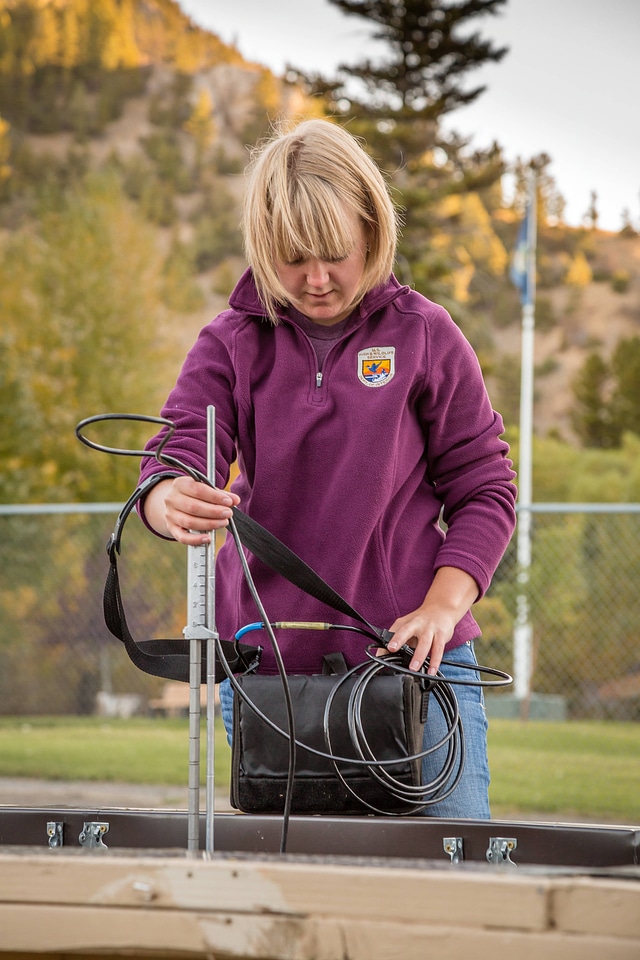 Biologist measures water velocity in a flume-1
