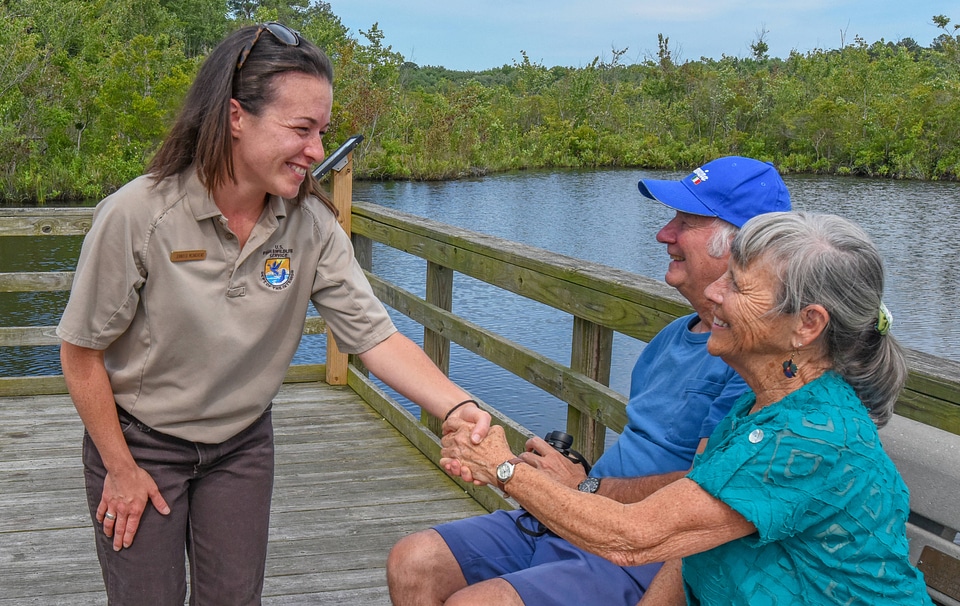 FWS Visitor services staffer greets visitors on boardwalk