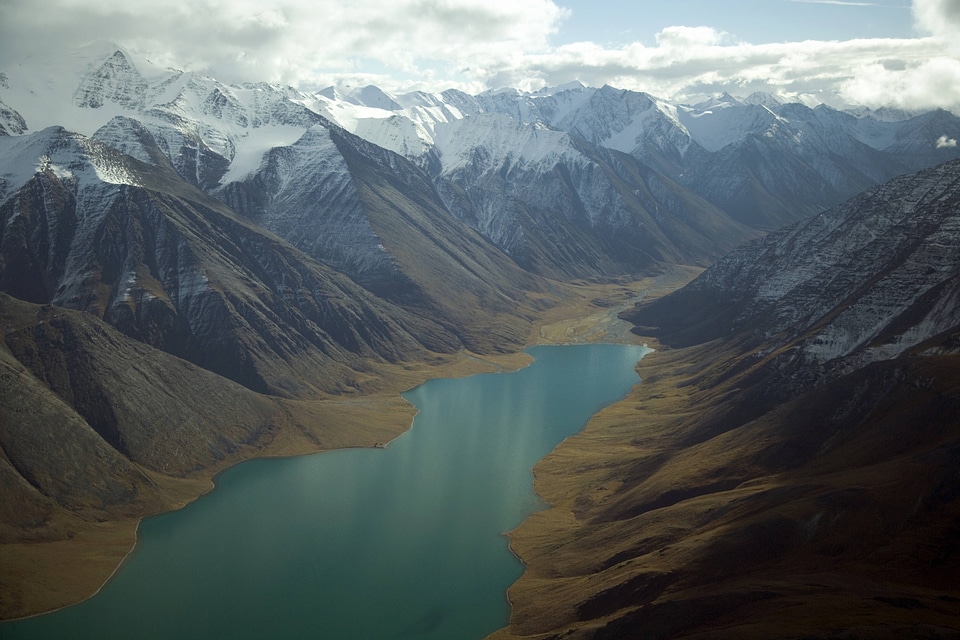 River running by snow-capped mountains