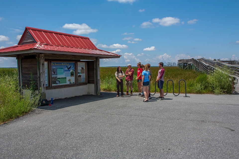 FWS staff talks to group of high school students at kiosk