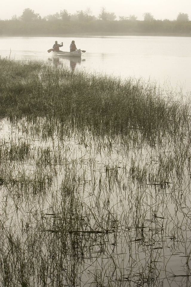 Paddling a canoe out of the fog