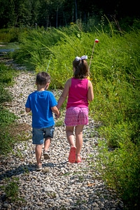Little boy and girl going fishing, walking along creek-1