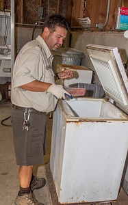 FWS staff employee prepares fish food-1