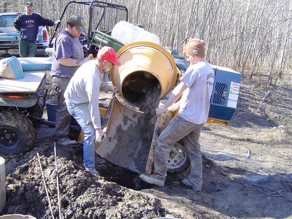 Workers pouring concrete for the Jameson Island Unit foot bridge