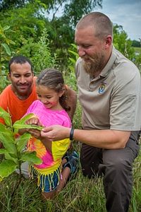 FWS employee shows a young girl (and dad) a Monarch caterpillar-1