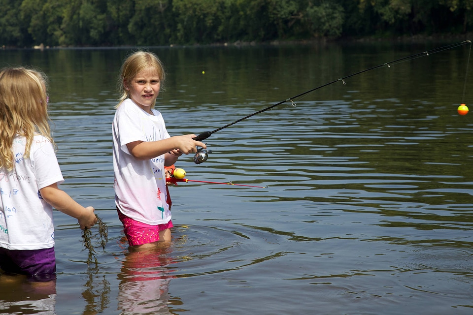 Girls fishing in knee deep water