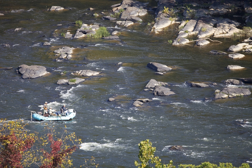 Manuvering  the raft through rapids while fly fishing the Potomac River