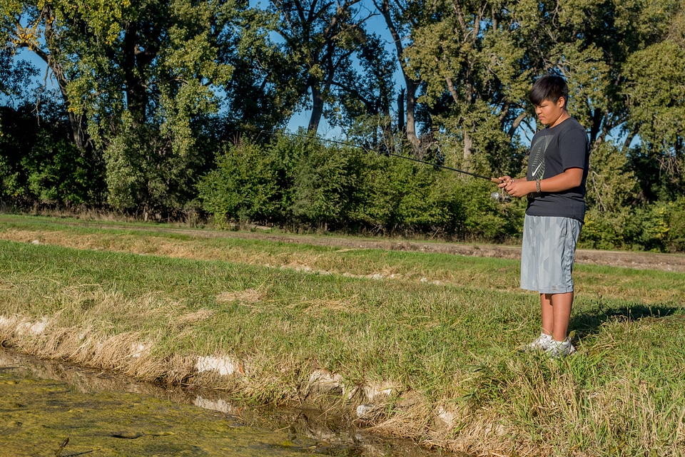 Boy fishes for bass