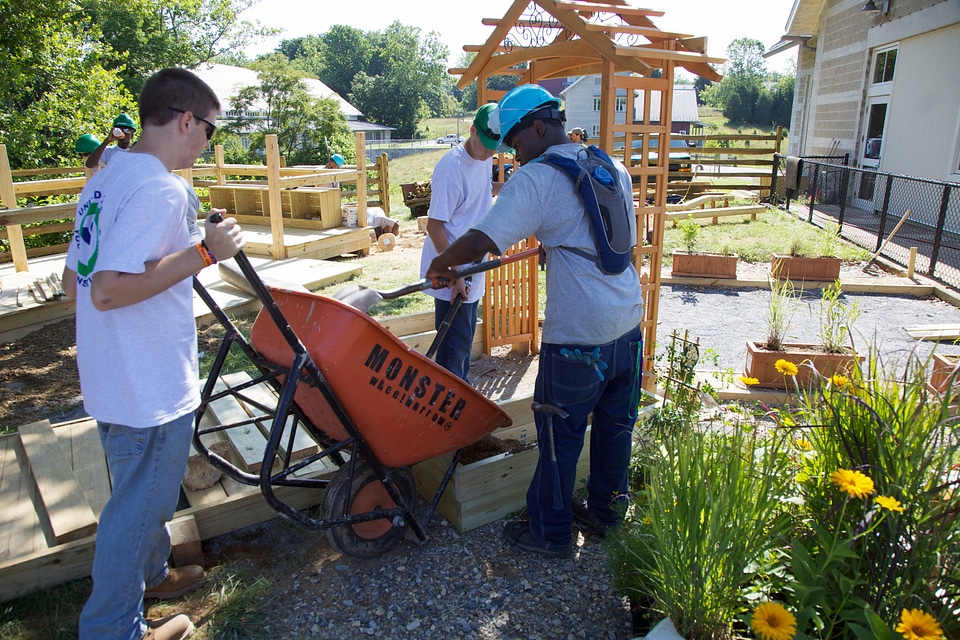 Youth Conservation Corps and volunteers filling a planter box