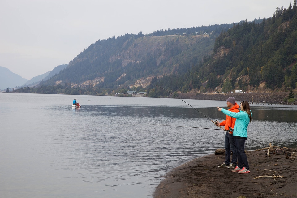 Couple fishing on the Columbia River shoreline