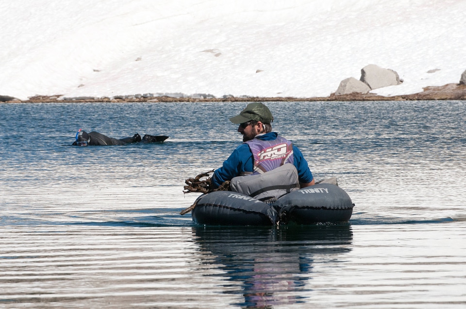 Biologist and photographer in lake
