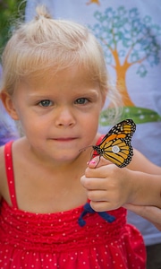 Little girl with tagged monarch on hand-3