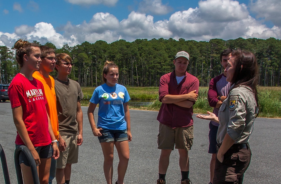 FWS staff talks to group of high school students at kiosk-1