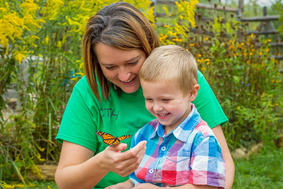 Woman and child with monarch butterfly