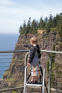 Youth pointing to Pillar Rock from viewing deck photo