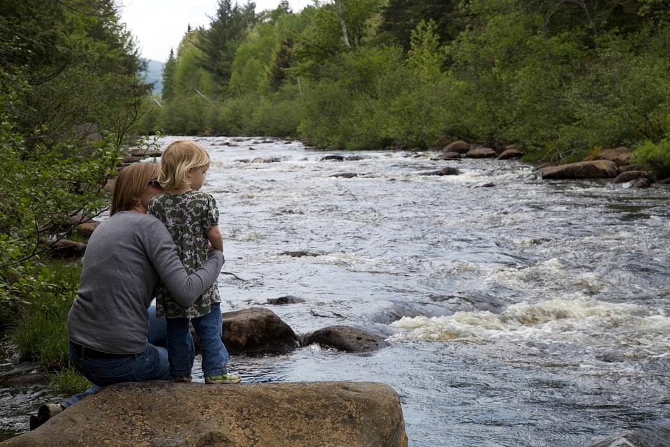 Mother and child looking at the stream