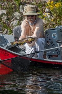 Angler with Brown trout on White River