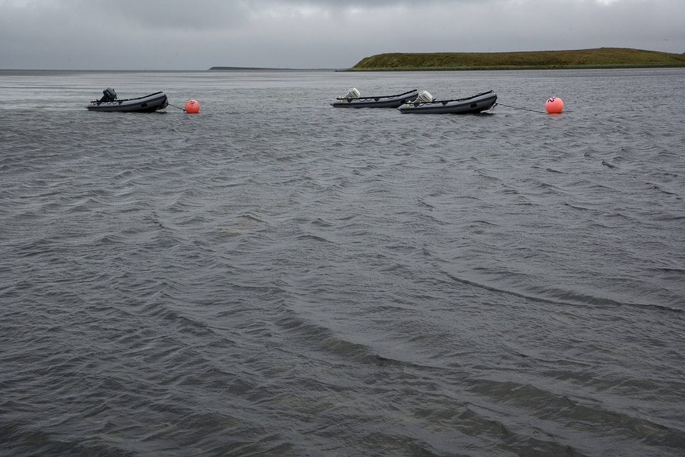 Boats moored in the water at Izembek National Wildlife Refuge