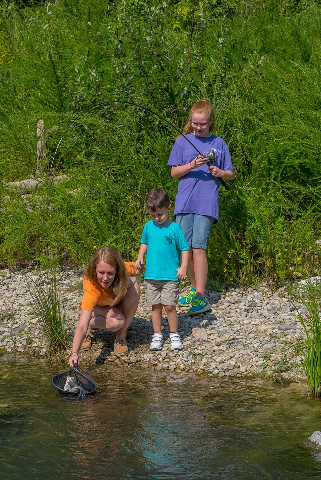 Family fishing, mother nets rainbow trout-8