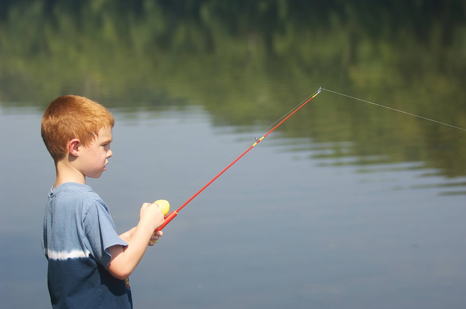Young boy with his fishing line in the water