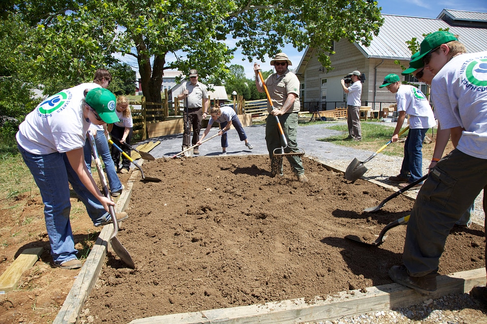 Group of Youth Conservation Corps gardening at the Outdoor Nature Explore Classroom