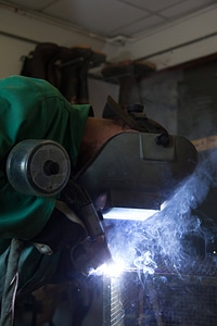 Service employee welds cages-4