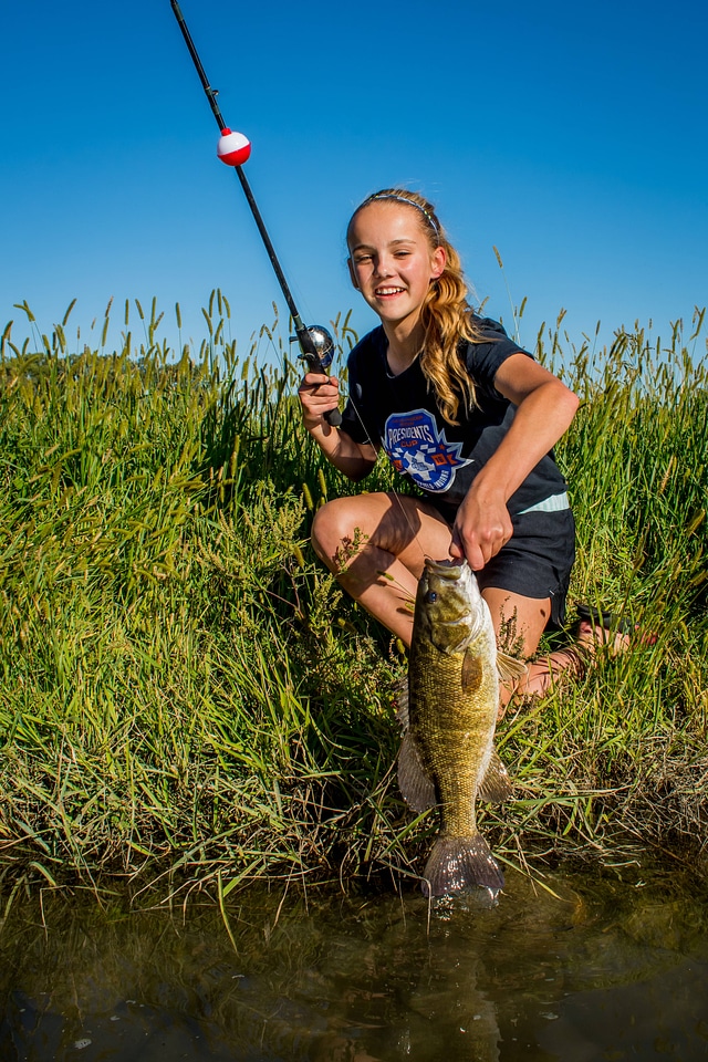 Girl catches smallmouth bass-3