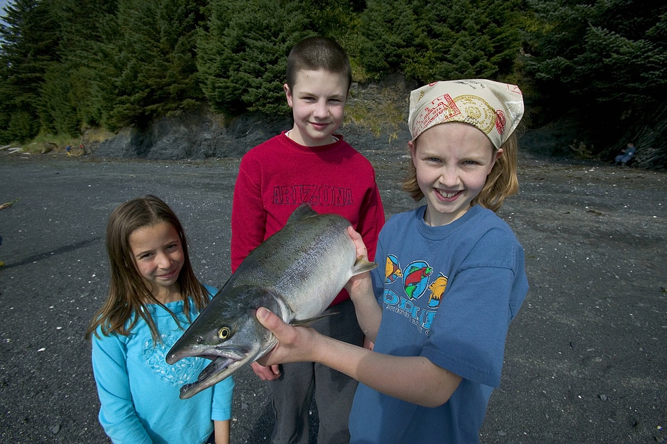 Children holding a fish at Kodiak National Wildlife Refuge photo