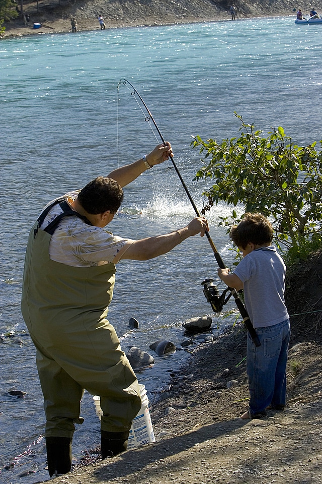 Father and son reeling in a big fish!