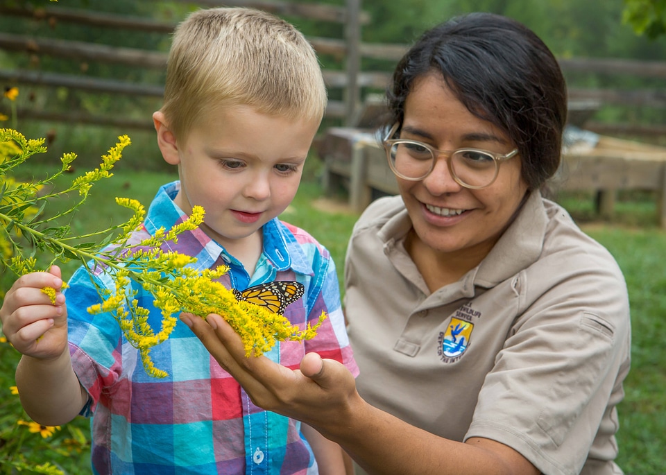 Child and FWS biologist with monarch butterfly-1