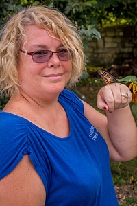 Monarch butterfly on woman's hand