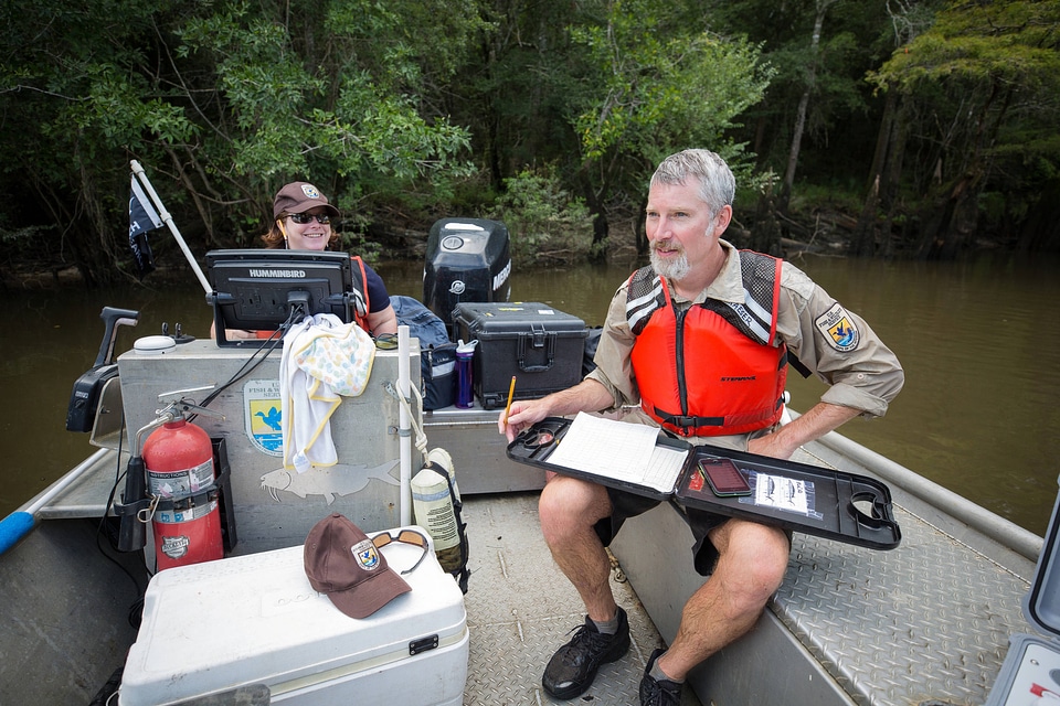 Biologists in boat study Gulf sturgeon in river-1