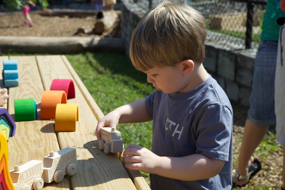 Young boy playing in the Nature Explore Outdoor Classroom
