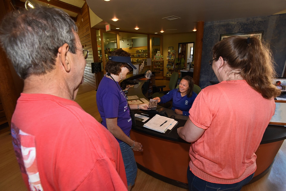 FWS Staff greets visitors at visitor center desk-8