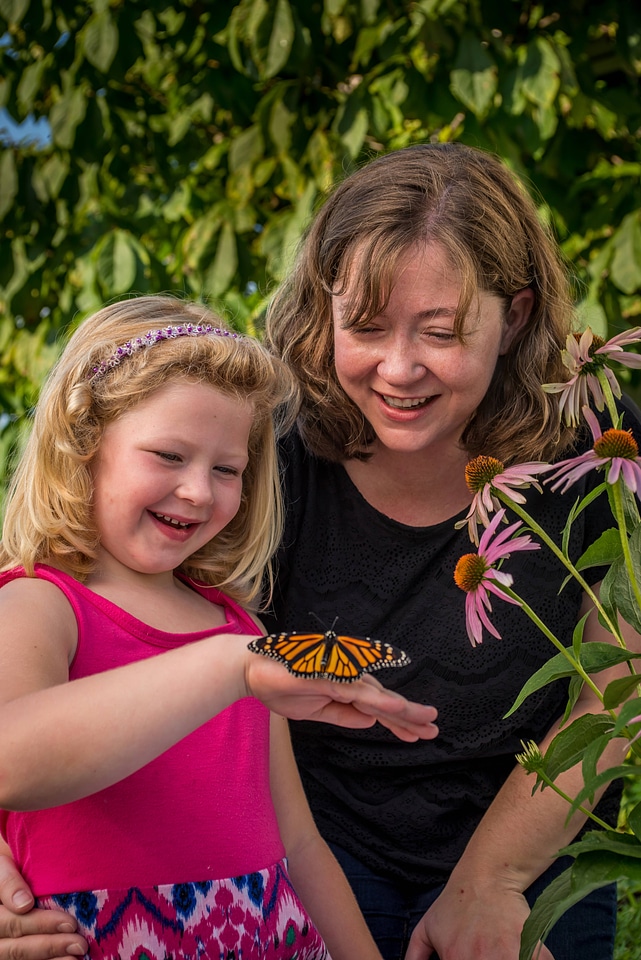 Mother and daughter with monarch