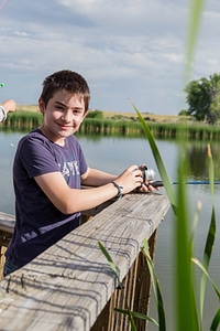 Young boy fishing from a dock