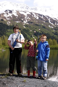 Three children with fishing poles at Portage