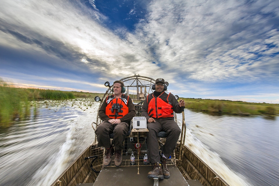 Employees maneauver an airboat at Bayou Sauvage NWR-4