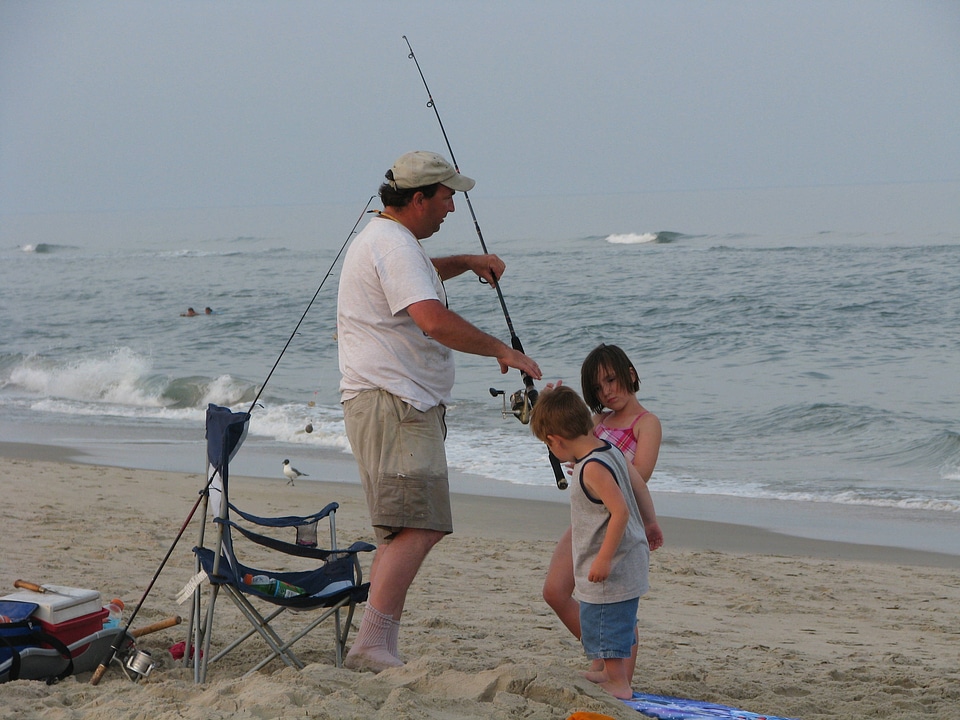 Dad and his children surf fishing