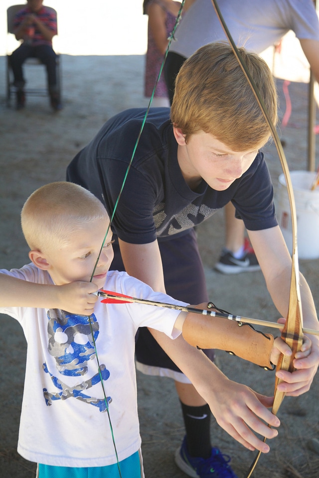 Children shooting bow and arrow